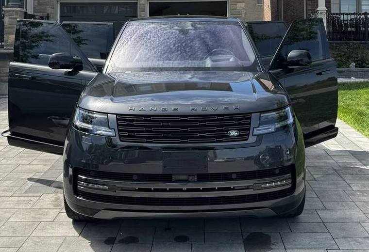 Black Range Rover in driveway with both front doors open