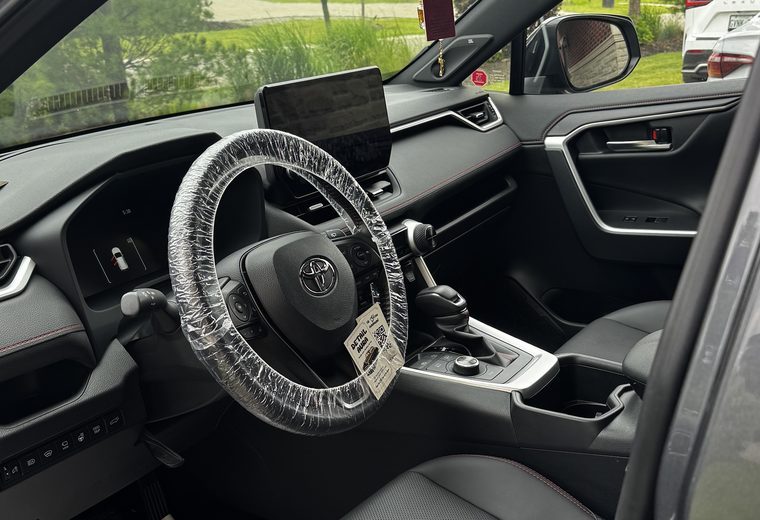 Toyota RAV4 cabin with a protective steering wheel cover fitted
