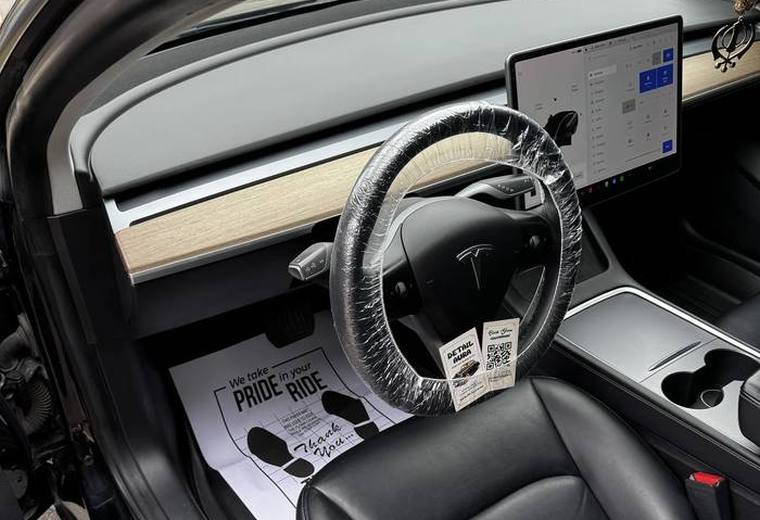 Tesla Model 3 cabin, centre screen and covered steering wheel